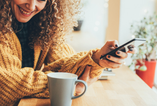 Woman using mobile device at a coffee shop